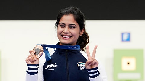 India's Manu Bhaker poses for a photograph with her bronze medal.